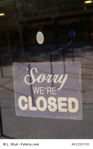 sign. sorry we're closed sign. sign on a glass door