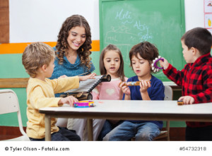 Children And Teacher Playing With Musical Instruments