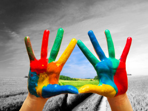 Painted colorful hands showing way to colorful happy life