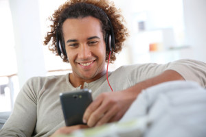 Cheerful attractive man listening to music