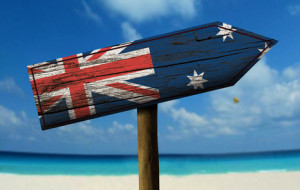 Australia flag wooden sign with a beach on background