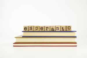 esperanto word on wood stamps stack on books, language and conversation concept